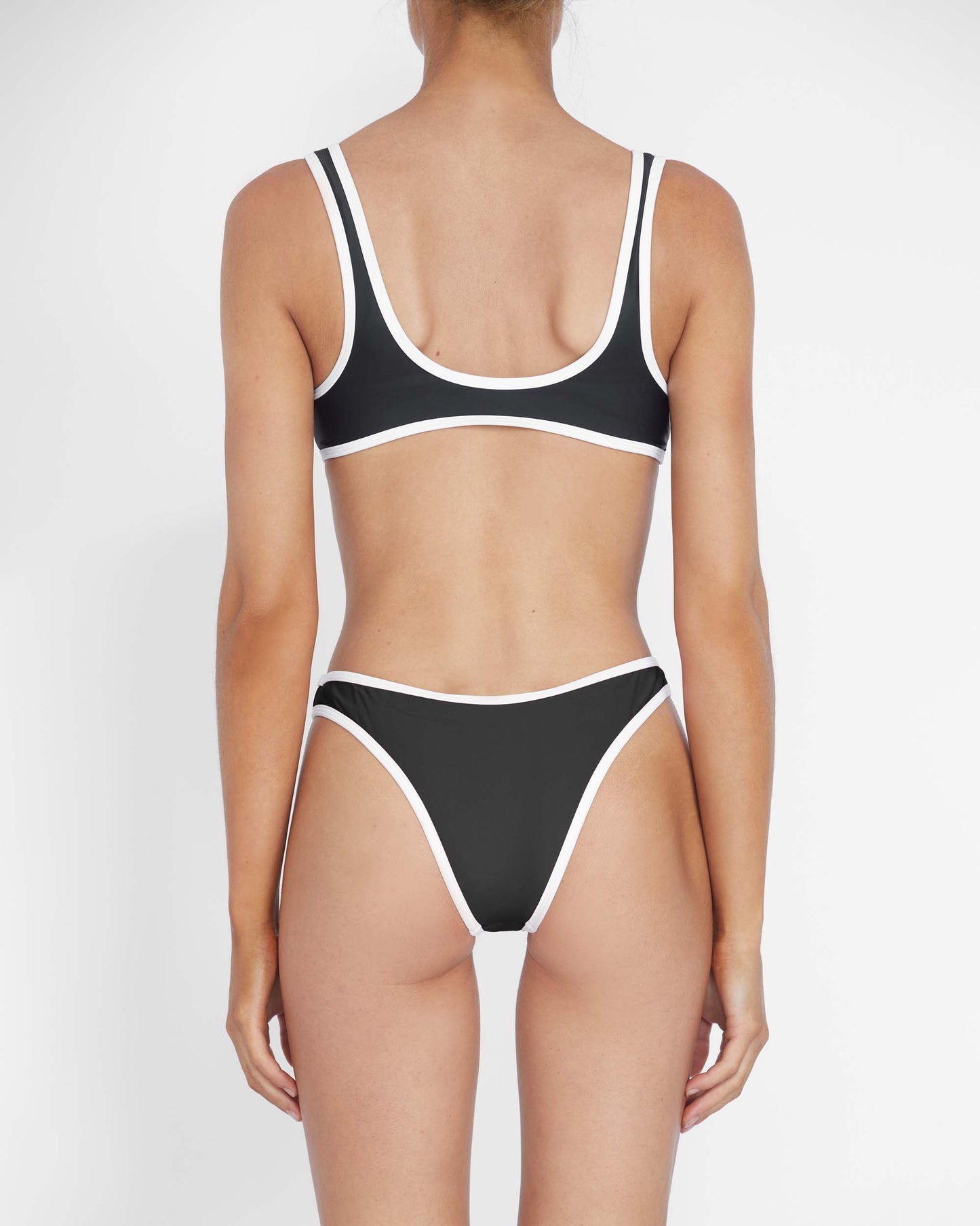 Studio image of model wearing the 90s Duo Pant in Black & White Contrast.