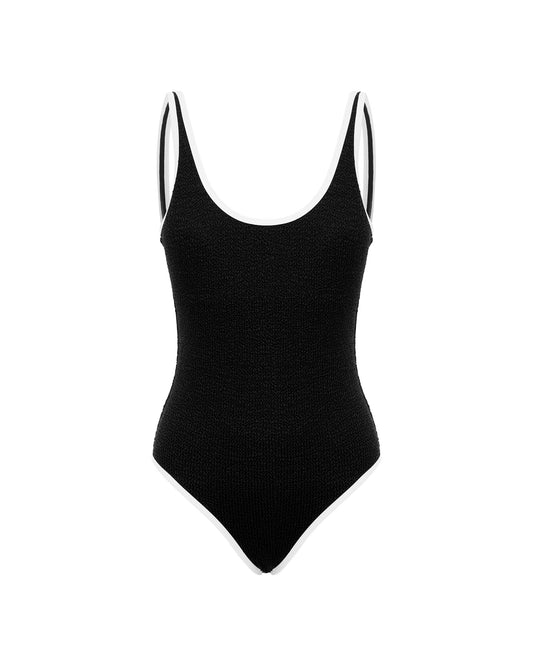 Studio image of the Backless Duo One Piece in Black and White Crimp, featuring its scooped neck and mid-high leg cuts. 