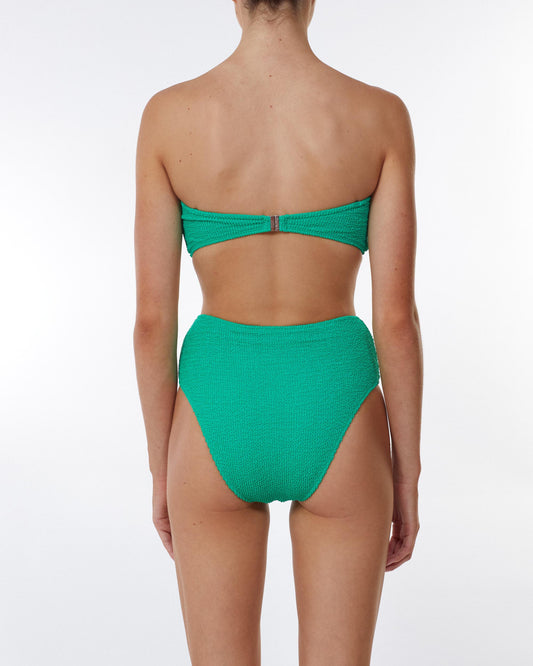 Studio image of model wearing the Waisted Pant in Emerald Crimp, showcasing its medium to cheeky bottom coverage and high-waisted fit.