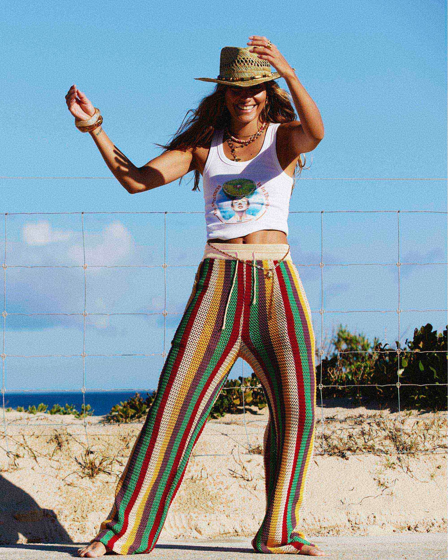 Model posing on the beach while wearing the Rib Tank in De Cuba. 