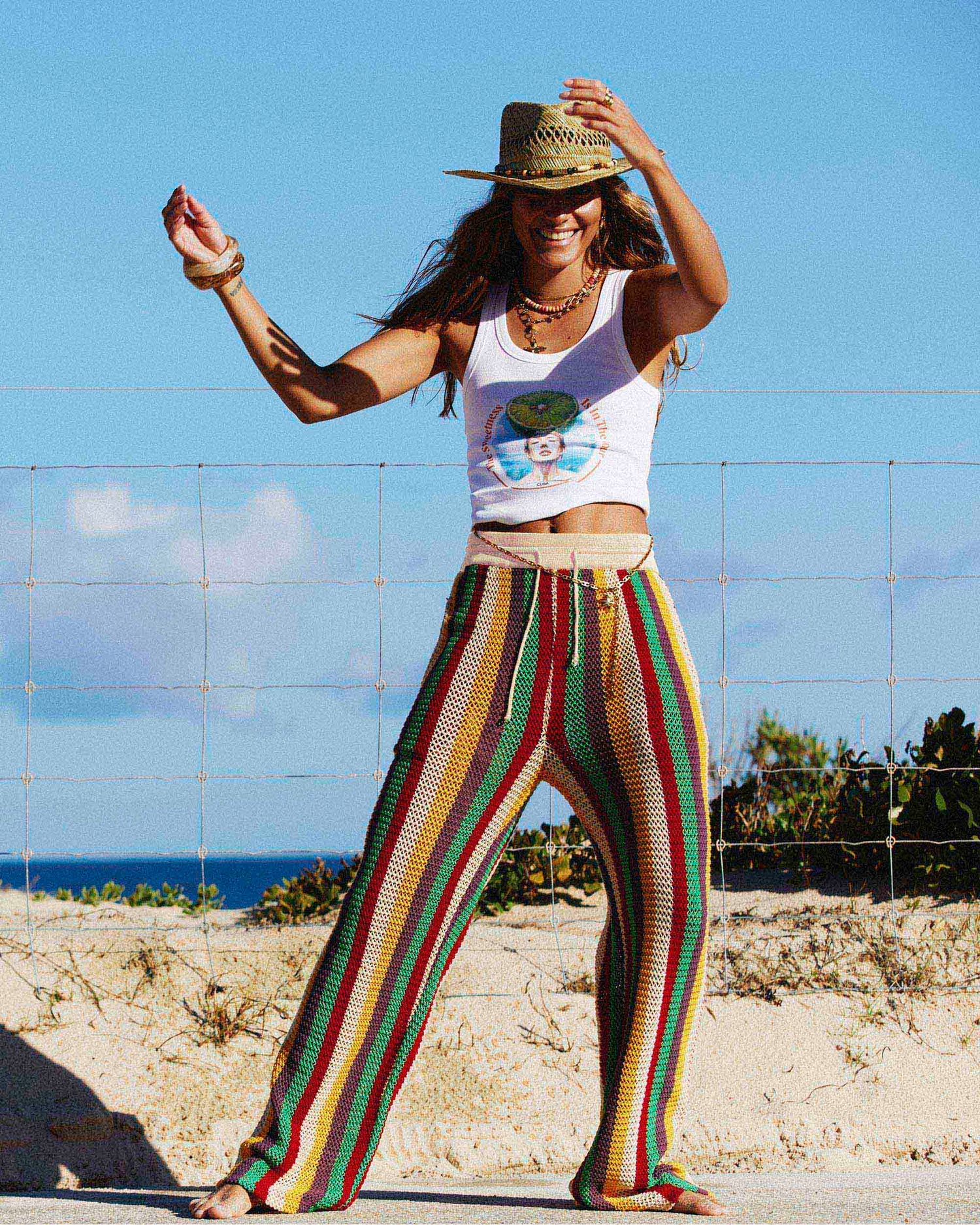 Model posing by the beach while wearing the Crochet Leisure Pant in Tulum. 