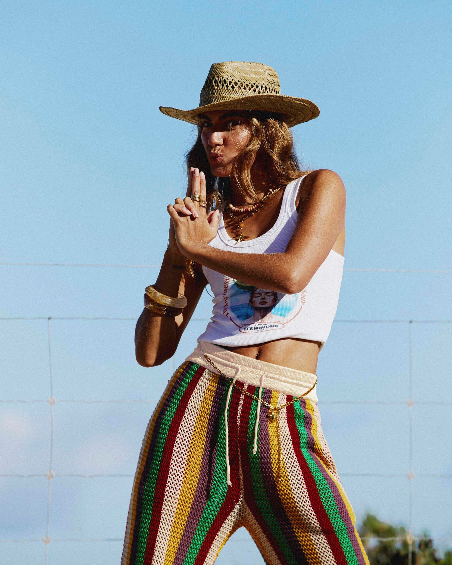 Model posing by the beach while wearing the Crochet Leisure Pant in Tulum. 