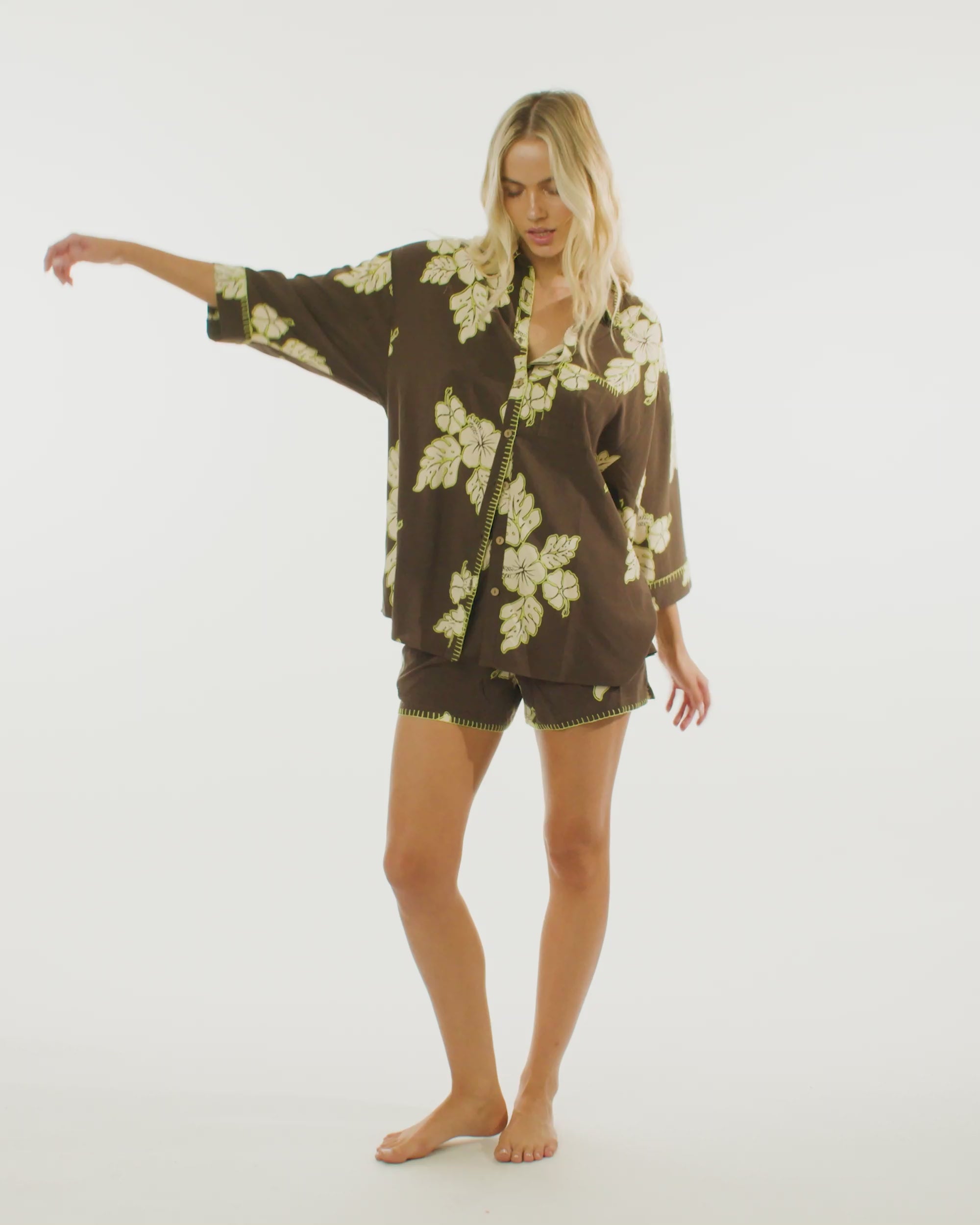 Video of model wearing the Vacay Shirt in Hibiscus, showcasing its floral design and oversized fit. 