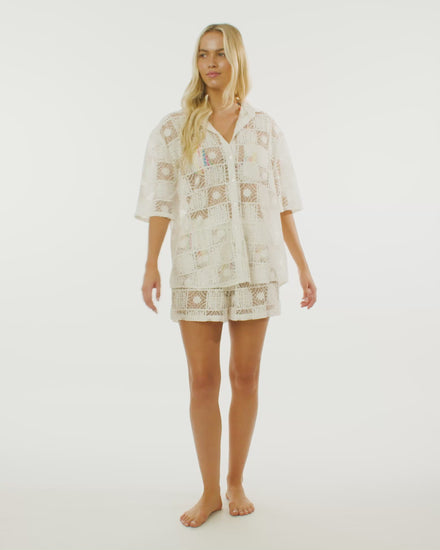 Video of model wearing the vacay shirt in margarita, showcasing the oversized fit and the lace design. 