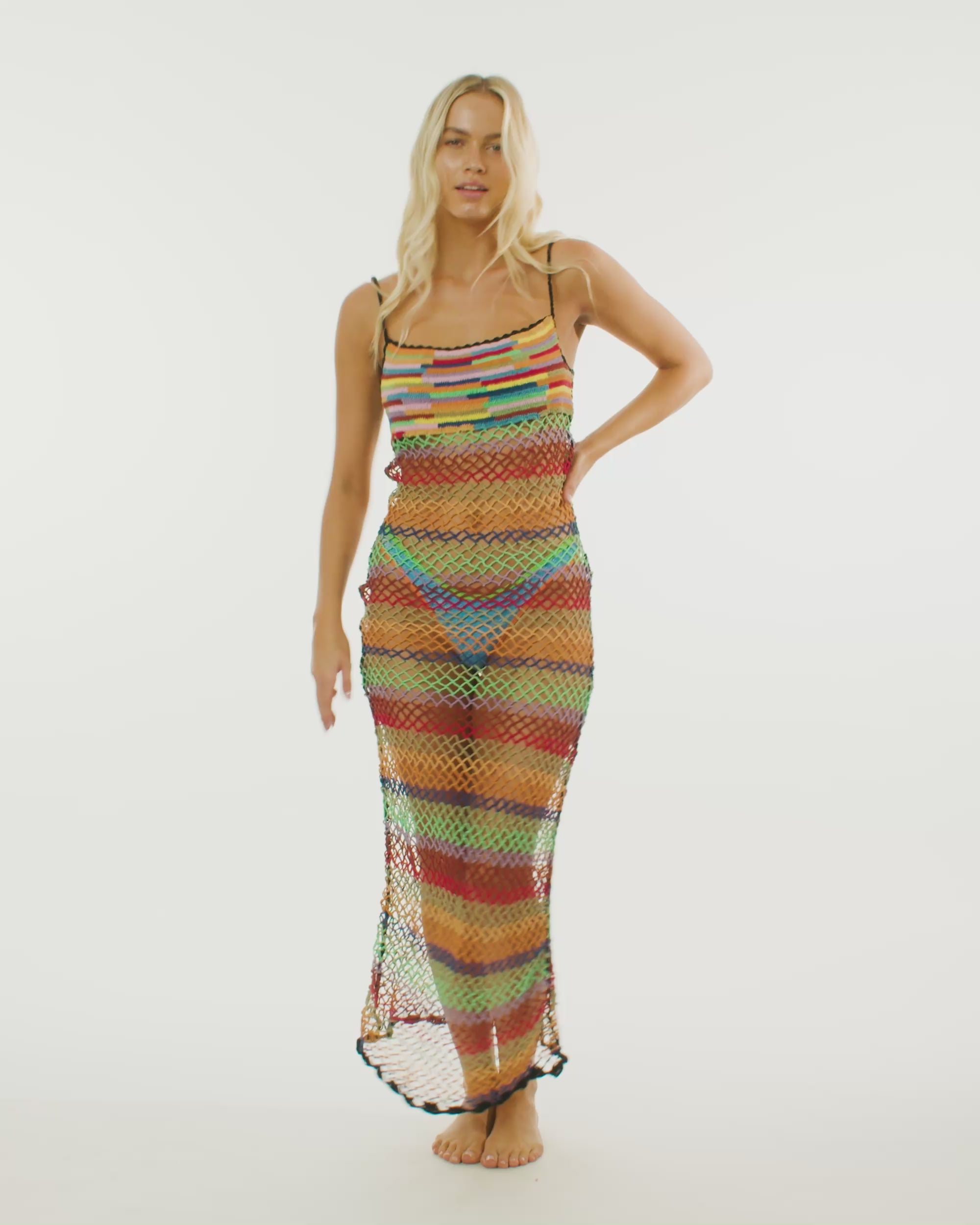 Video of model wearing the crochet maxi dress in suffolk, featuring its hand-crocheted design and open weave crochet netting.