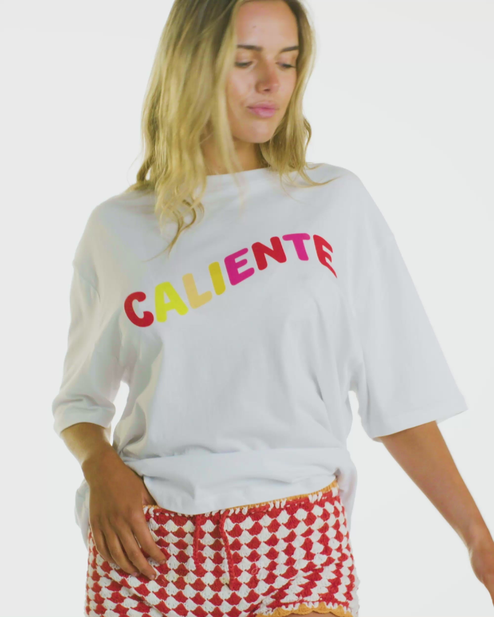 Video of model wearing the Box Tee in Caliente, showcasing its oversized fit and mid-length sleeves. 