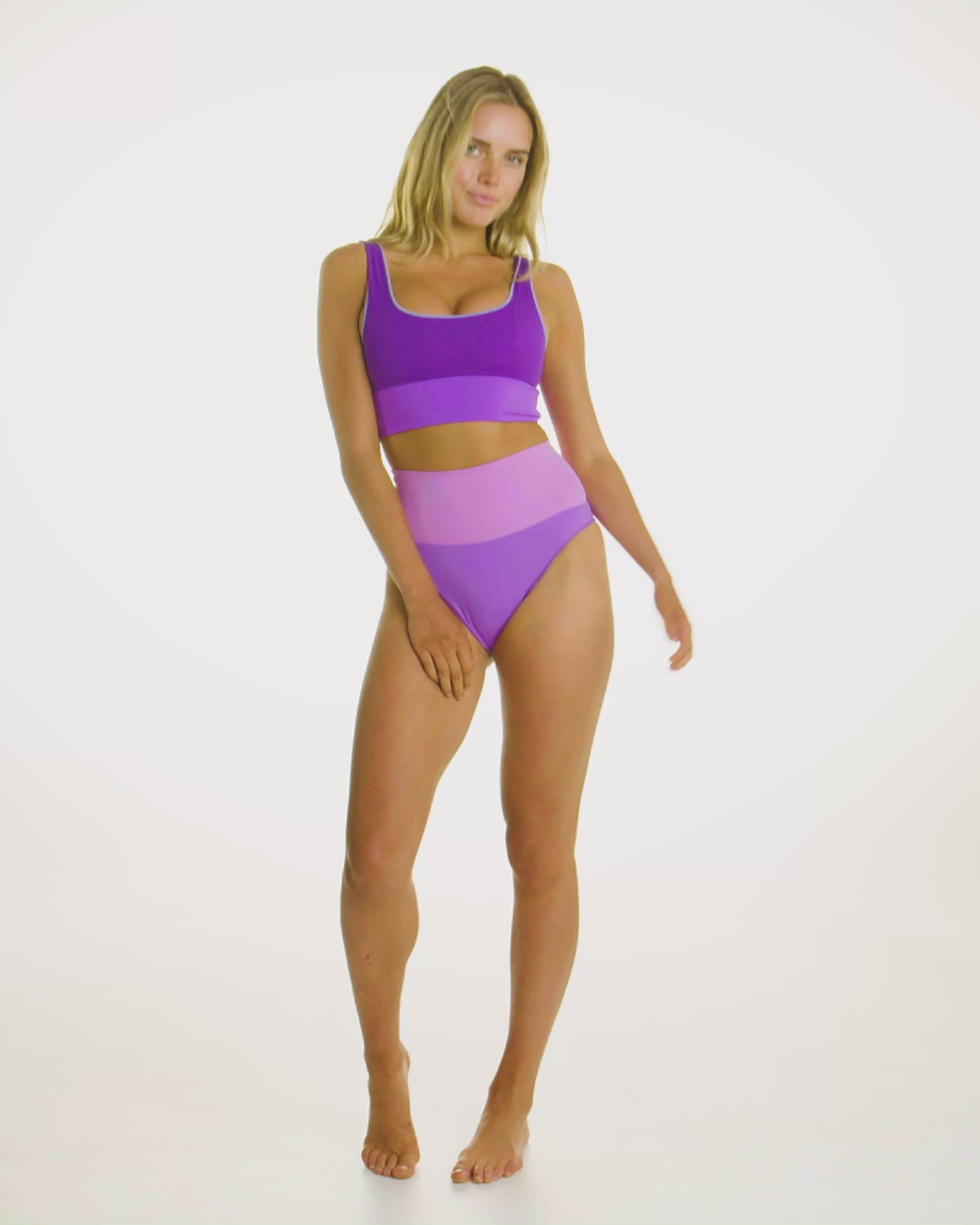 Video of model wearing the Contour Crop Top in Periwinkle, showcasing its high-waisted compression fit. 