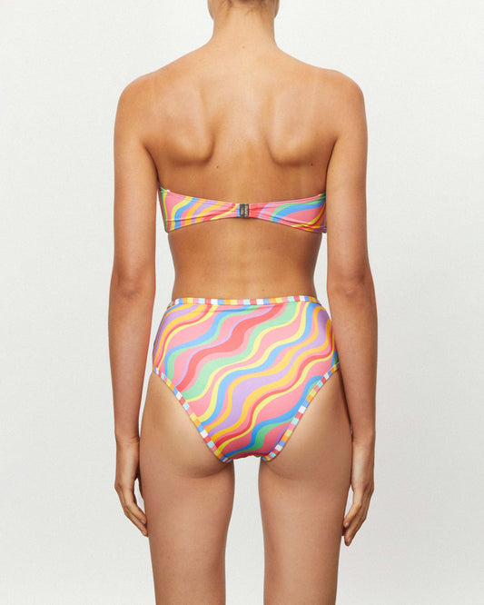 Studio image of model wearing the Waisted Duo Pant in Rainbow, highlighting its mid-high waistline and moderate bottom coverage.  