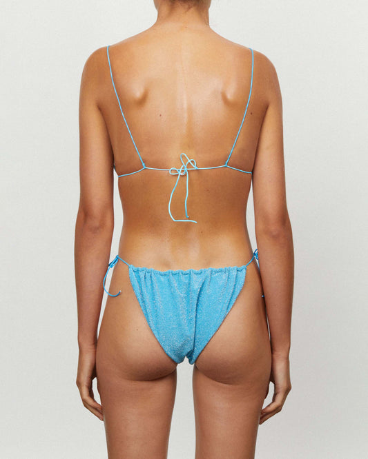 On body back of the String Top - Turquoise Lurex. 